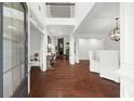 Bright entryway with hardwood floors, high ceilings, and an open view into the dining and living area at 4435 Manor Creek Dr, Cumming, GA 30040