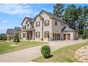 A spacious two-story home features a three-car garage and a long driveway, offering ample parking at 6861 Louis Dr, Locust Grove, GA 30248