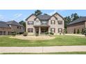 Beautiful home featuring meticulously maintained lawn, bushes, and flowerbeds for great curb appeal at 6861 Louis Dr, Locust Grove, GA 30248