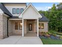 Welcoming entrance of a brick home featuring modern architectural details and manicured landscaping at 863 N Bay Overlook, Villa Rica, GA 30180