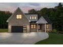 Beautiful exterior view of modern home with brick, black trim and a driveway at dusk at 863 N Bay Overlook, Villa Rica, GA 30180