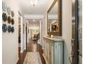 Inviting entryway featuring hardwood floors, light walls, stylish decor and a view into the living spaces at 2965 Westlington Cir, Cumming, GA 30040