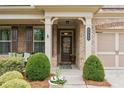 Inviting front porch of a brick home with classic columns and well-maintained landscaping at 2965 Westlington Cir, Cumming, GA 30040