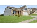 Lovely single-Gathering home featuring a covered porch, lush lawn, and attached two-car garage at 48 Masters Dr, Villa Rica, GA 30180