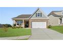 Charming single-Gathering home with brick and siding accents, a manicured lawn, and a 2-car garage at 48 Masters Dr, Villa Rica, GA 30180