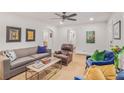 Bright living room with neutral walls, ceiling fan, and comfortable seating arrangement at 728 Antone Nw St, Atlanta, GA 30318