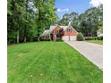 Traditional brick home with well-kept lawn, offering a glimpse of comfortable suburban living at 1340 Gran Forest Dr, Cumming, GA 30041