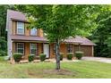 Well-kept two-story home with lush landscaping, a spacious front yard, and a driveway at 4424 English Loop, Stonecrest, GA 30038