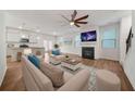 Open-concept living area with hardwood floors, fireplace, and adjacent modern kitchen at 826 Bentley Dr, Fairburn, GA 30213