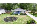 Aerial view of the home's front yard showcasing landscaping, blue accents, and mature trees at 957 Sharon Se Cir, Smyrna, GA 30080