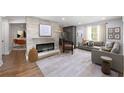 Spacious living room featuring hardwood floors, a modern fireplace, and an open floor plan at 957 Sharon Se Cir, Smyrna, GA 30080
