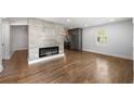 Bright living room features beautiful hardwood floors, a modern fireplace, and an open floor plan at 957 Sharon Se Cir, Smyrna, GA 30080