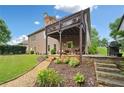 Spacious backyard featuring a deck, patio, and lush landscaping at 6245 Hampton Golf Club Dr, Cumming, GA 30041