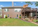 Spacious backyard featuring a deck, patio, and well-maintained lawn at 6245 Hampton Golf Club Dr, Cumming, GA 30041