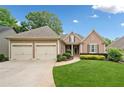 Charming one-story home featuring manicured lawn and two-car garage at 6245 Hampton Golf Club Dr, Cumming, GA 30041