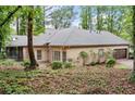 Back exterior of home showing screened-in porch and attached garage at 120 Bent Creek Dr, Woodstock, GA 30189