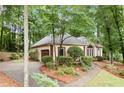Exterior side view of home showing the attached garage and landscaping at 120 Bent Creek Dr, Woodstock, GA 30189