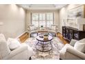 Cozy living room with hardwood floors, tray ceilings, designer furniture, and plantation shutters at 2059 Howell Mill Nw Rd, Atlanta, GA 30318