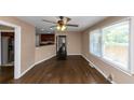 Living room view leading to kitchen with hardwood floors, ceiling fan and lots of light from windows at 2702 Rollingwood Se Ln, Atlanta, GA 30316