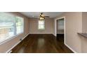 Bright living room features sleek hardwood floors, a ceiling fan, and large windows for natural light at 2702 Rollingwood Se Ln, Atlanta, GA 30316