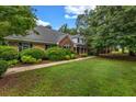 A charming brick home featuring mature landscaping and a well-maintained lawn at 362 Clyde Ct, Mcdonough, GA 30252