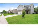 Street view of well-manicured front yard leading to a two-story home with an attached garage at 40 Oakwood Dr, Covington, GA 30016