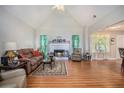 Inviting living room with a vaulted ceiling, fireplace, hardwood floors, and lots of natural light at 1907 S Van Wert Rd, Villa Rica, GA 30180