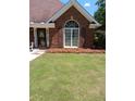 Exterior showing a manicured lawn and decorative flowers at 512 Ollas Walk, Mcdonough, GA 30252