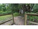 View of backyard with fenced in area and mature trees offering tons of privacy at 5710 Cardigan Trce, Sugar Hill, GA 30518
