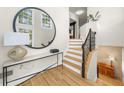 Welcoming foyer with hardwood floors, staircase, and stylish decor at 5968 Reddington Way, Sandy Springs, GA 30328