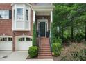 Inviting front entrance featuring brick stairs and a covered porch at 5968 Reddington Way, Sandy Springs, GA 30328