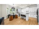 Bright kitchen with white cabinetry, stainless steel appliances, and breakfast nook at 5968 Reddington Way, Sandy Springs, GA 30328