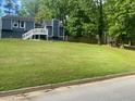 View of the home's front exterior with well-manicured lawn, showcasing its curb appeal at 6701 Knollwood Cir, Douglasville, GA 30135