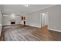 Open-concept living room featuring wood floors, fireplace, and an open view of the kitchen at 1707 Taylor Ave, Atlanta, GA 30344