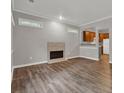 Bright living room showcases wood floors, fireplace, and a view into the kitchen at 1707 Taylor Ave, Atlanta, GA 30344