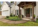 Inviting entrance with a wood-covered front porch and well-maintained landscaping at 2205 Waters Ferry Dr, Lawrenceville, GA 30043