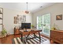Bright home office with hardwood floors, large window, and stylish decor at 2205 Waters Ferry Dr, Lawrenceville, GA 30043