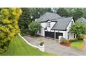 Rear exterior of home showcasing a 2-car garage, well-maintained yard, and mature trees at 2714 Twin Leaf Trl, Marietta, GA 30062