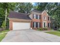 Well maintained two-story brick home with black shutters and an attached two-car garage at 3500 Stillwood Dr, Snellville, GA 30039