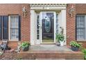 Inviting front entrance with a decorative glass door, sidelights, and classic brick surround at 3500 Stillwood Dr, Snellville, GA 30039