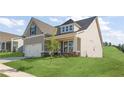Charming craftsman-style home with a manicured lawn and two-car garage at 49 Masters Dr, Villa Rica, GA 30180