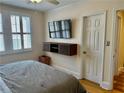 Bright bedroom with shuttered windows, modern floating console, and hardwood floors at 1078 Piedmont Ne Ave # 206, Atlanta, GA 30309