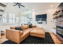Cozy living room features a brick fireplace, wood floors, and a comfortable leather sectional at 1078 Piedmont Ne Ave # 206, Atlanta, GA 30309