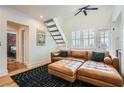 Inviting living room with wood floors, leather sectional, and staircase to the upper level at 1078 Piedmont Ne Ave # 206, Atlanta, GA 30309