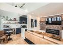 Bright living room next to a well-equipped kitchen with brick accent wall and fireplace at 1078 Piedmont Ne Ave # 206, Atlanta, GA 30309