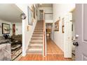 Inviting foyer with staircase, tile flooring, and wood accents at 1382 Koble Mill Ln, Riverdale, GA 30296