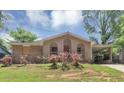 Charming brick home featuring a covered front porch, complemented by a lush green lawn and mature trees at 5267 Sheppard Ln, Stone Mountain, GA 30083