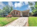 Charming brick home featuring a covered front porch and long driveway, complemented by a lush green lawn and mature trees at 5267 Sheppard Ln, Stone Mountain, GA 30083