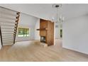 Open floor plan living room and staircase with wood burning fireplace with lots of natural light at 112 Valley Rd, Stockbridge, GA 30281