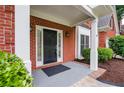 Close-up of the front door, showcasing a black door with sidelights and a gray porch at 1245 Grace Hadaway Ln, Lawrenceville, GA 30043